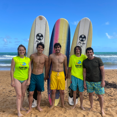 a group of people standing on a beach posing for the camera