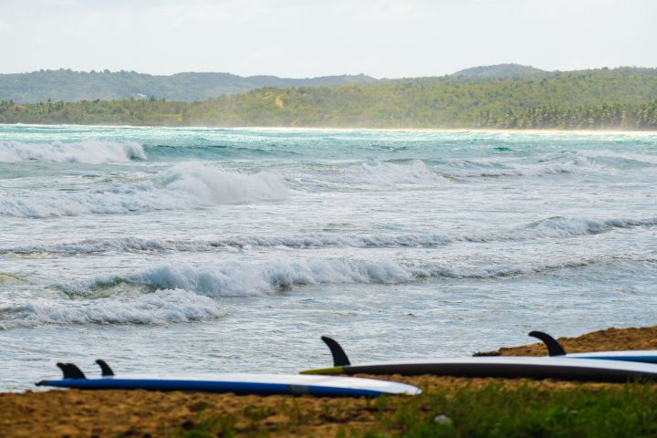 a person riding a surf board on a body of water