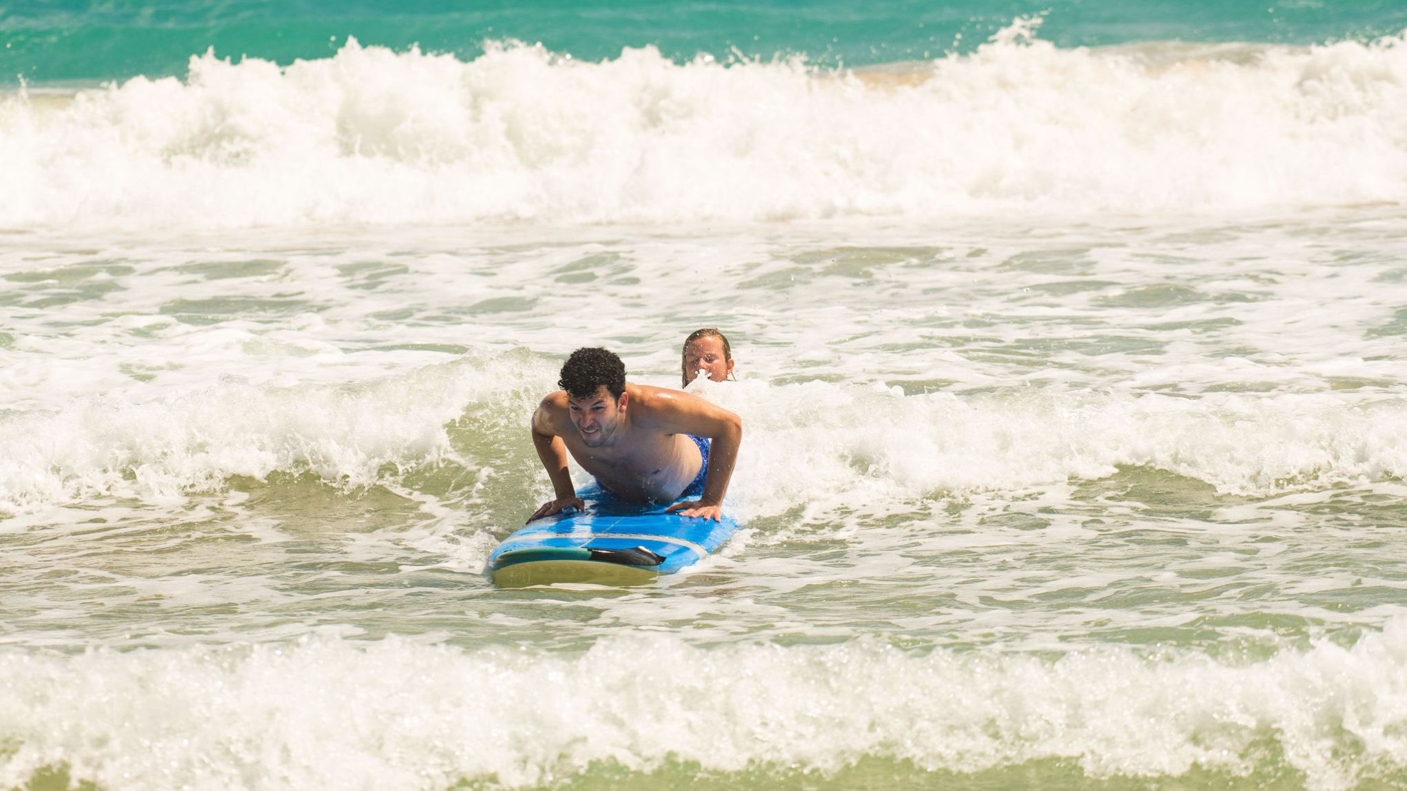a person riding a wave on a surfboard in the ocean
