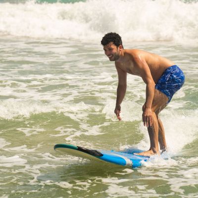 Carlos Ever Fonseca riding a wave on a surfboard in the water