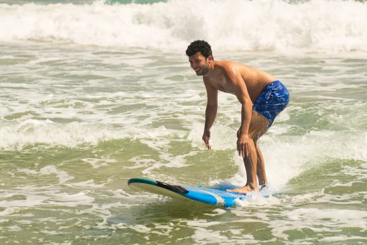 Carlos Ever Fonseca riding a wave on a surfboard in the water